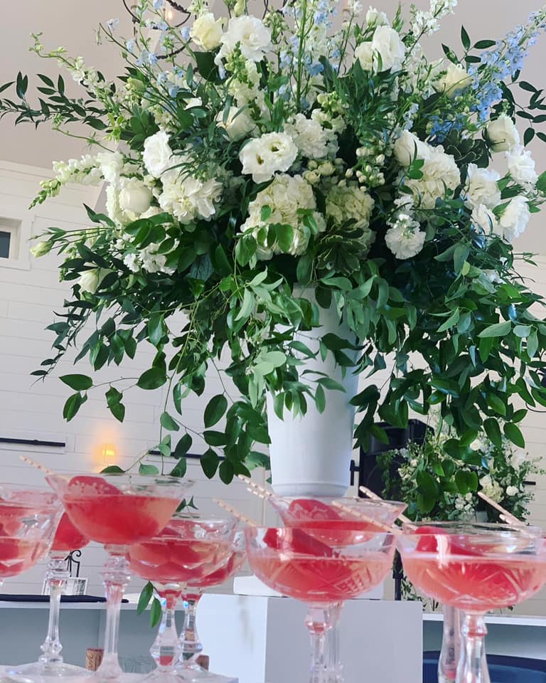 flowers with green leaves and red drinks in glasses