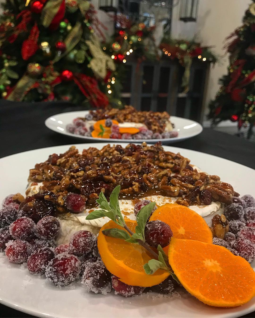 2 plates with candied oranges and cherries with caramel covered pecans