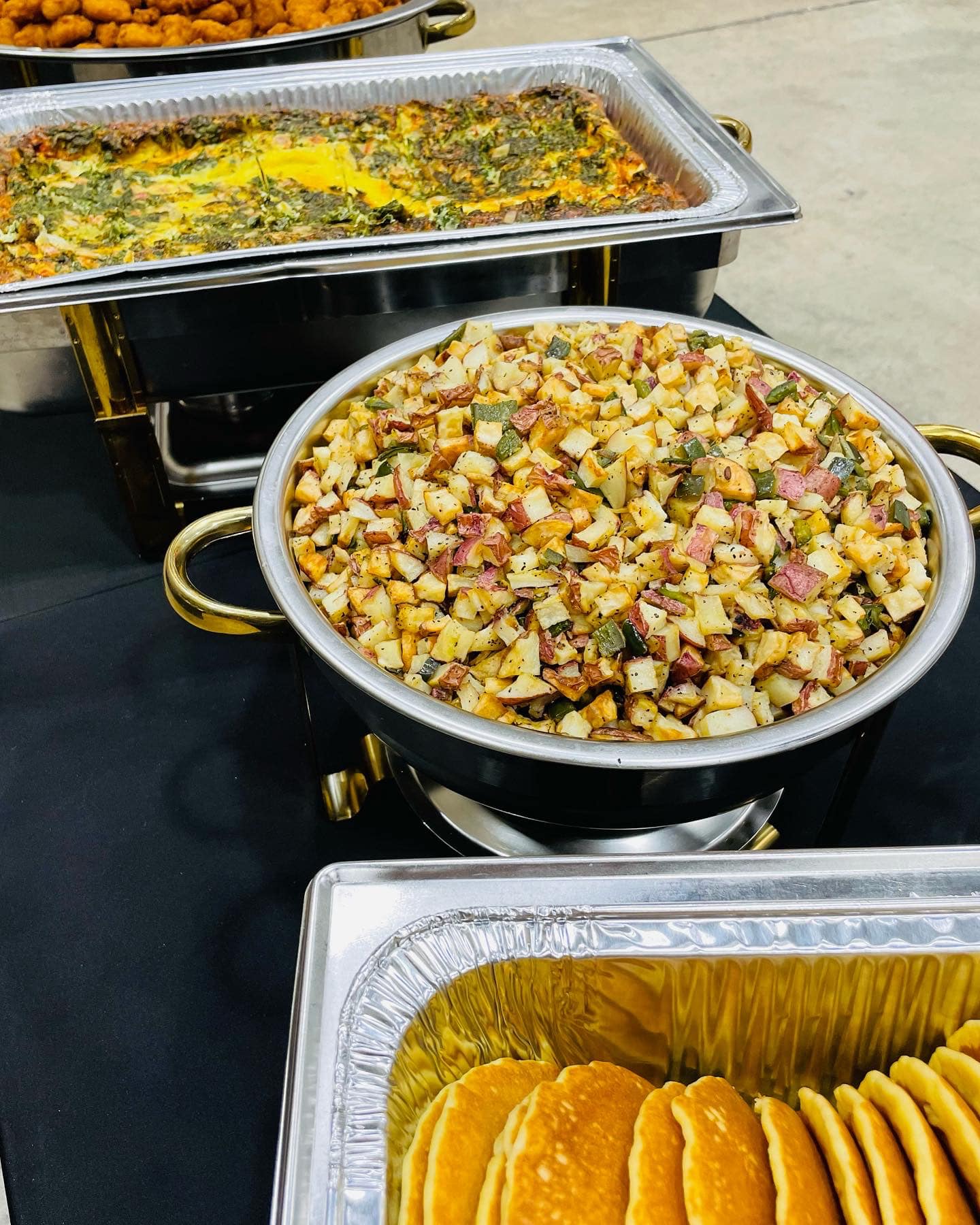catering table with different dishes in different pans